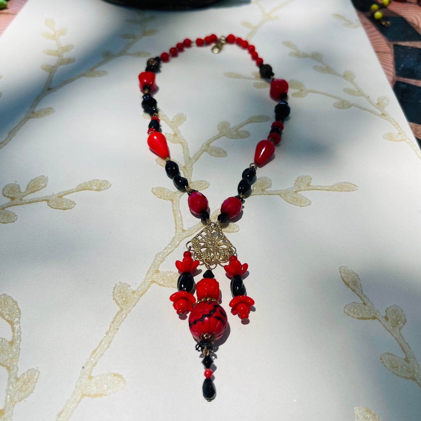 Hand-Made With Vintage Red and Black Beads and a Resin cinnabar drop.